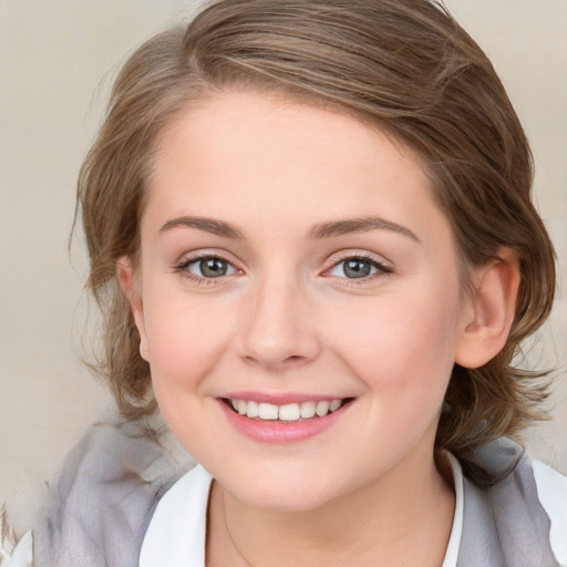 Joyful white young-adult female with medium  brown hair and blue eyes