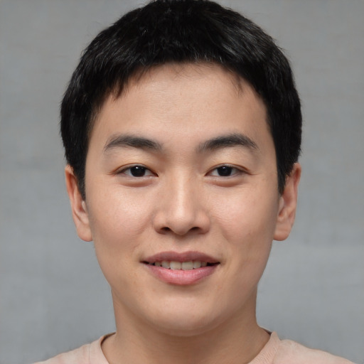 Joyful asian young-adult male with short  black hair and brown eyes