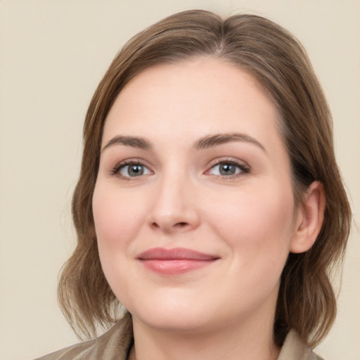 Joyful white young-adult female with medium  brown hair and green eyes