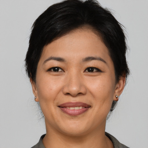 Joyful asian young-adult female with medium  brown hair and brown eyes