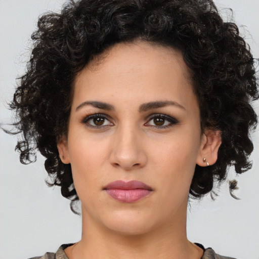 Neutral latino young-adult female with medium  brown hair and brown eyes