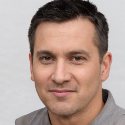 Joyful white adult male with short  brown hair and brown eyes