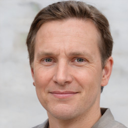 Joyful white adult male with short  brown hair and grey eyes