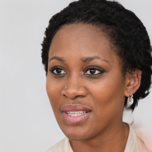 Joyful black young-adult female with short  black hair and brown eyes