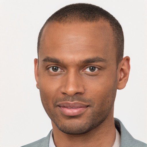 Joyful black young-adult male with short  brown hair and brown eyes