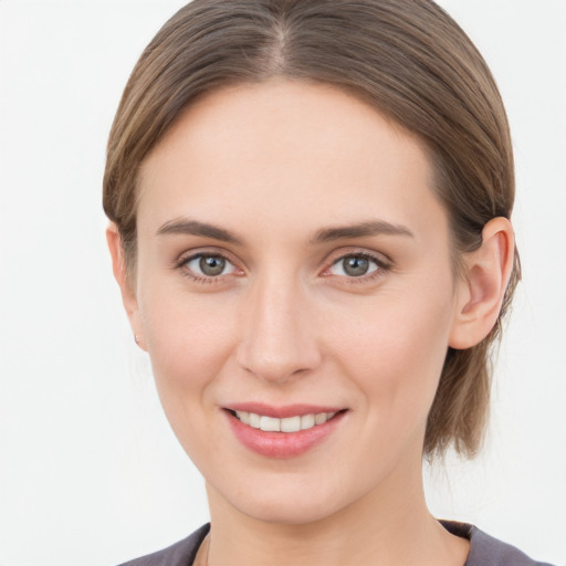 Joyful white young-adult female with medium  brown hair and grey eyes