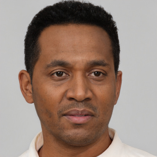 Neutral latino adult male with short  black hair and brown eyes