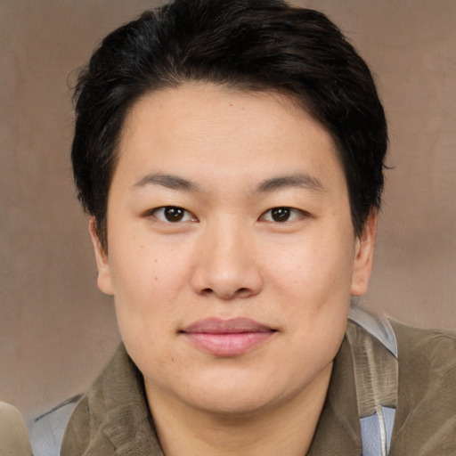 Joyful asian young-adult male with medium  brown hair and brown eyes