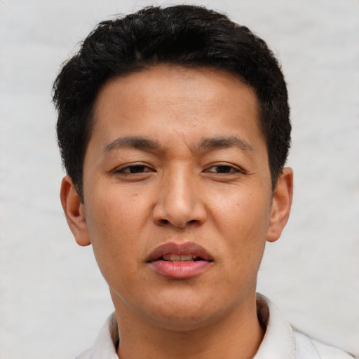Joyful asian young-adult male with short  brown hair and brown eyes