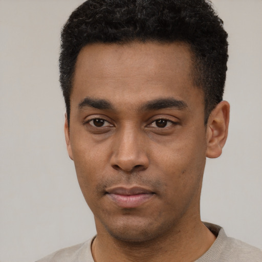 Neutral black young-adult male with short  black hair and brown eyes