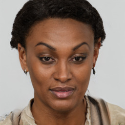 Joyful black adult female with short  brown hair and brown eyes