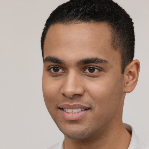 Joyful white young-adult male with short  black hair and brown eyes