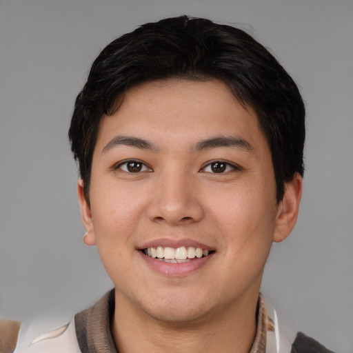 Joyful asian young-adult male with short  brown hair and brown eyes