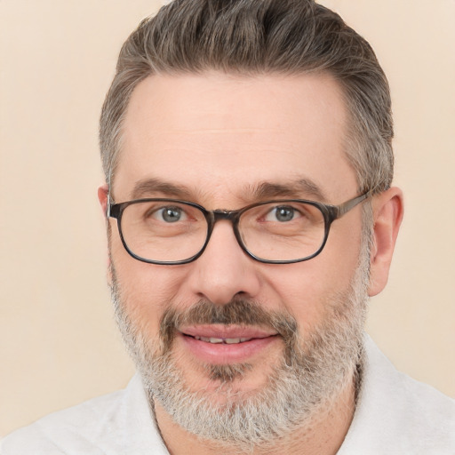 Joyful white adult male with short  gray hair and brown eyes