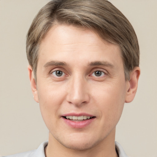 Joyful white adult male with short  brown hair and grey eyes