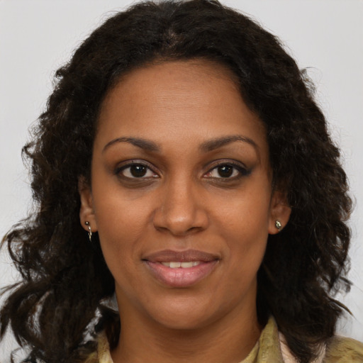 Joyful black adult female with medium  brown hair and brown eyes