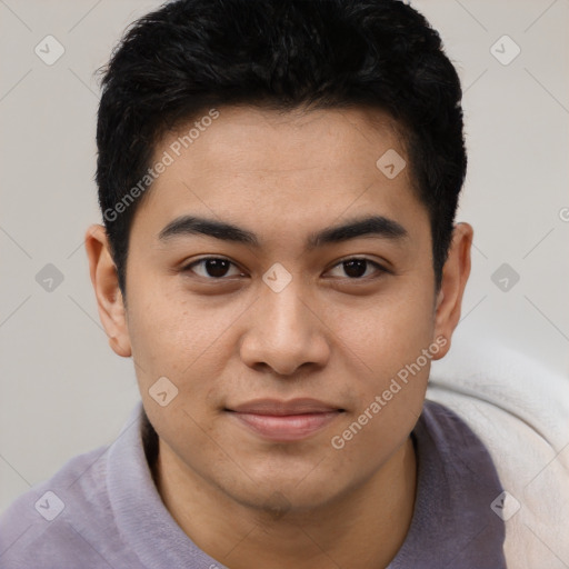 Joyful latino young-adult male with short  brown hair and brown eyes