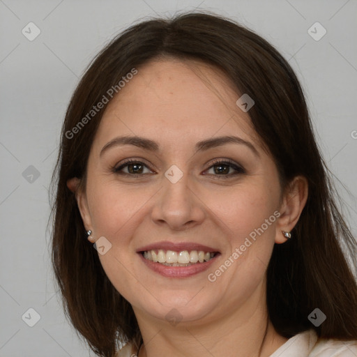 Joyful white adult female with long  brown hair and brown eyes