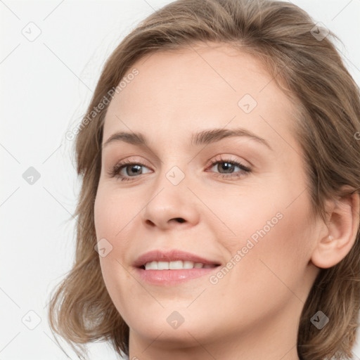 Joyful white young-adult female with medium  brown hair and blue eyes