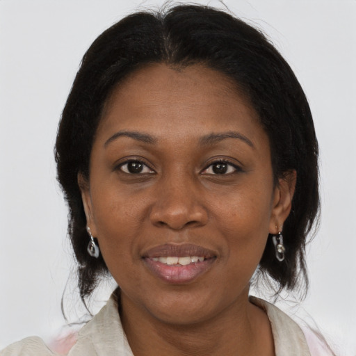 Joyful black adult female with medium  brown hair and brown eyes