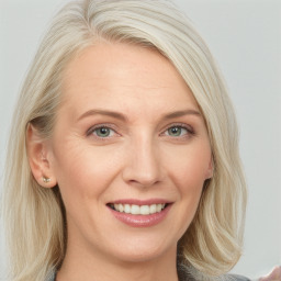 Joyful white young-adult female with long  brown hair and blue eyes