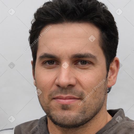 Joyful white young-adult male with short  black hair and brown eyes