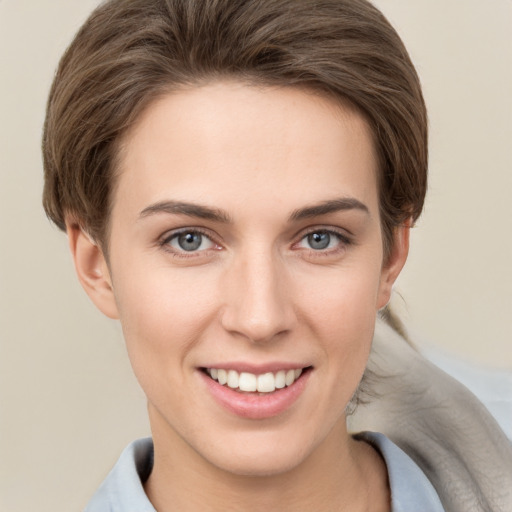 Joyful white young-adult female with short  brown hair and grey eyes