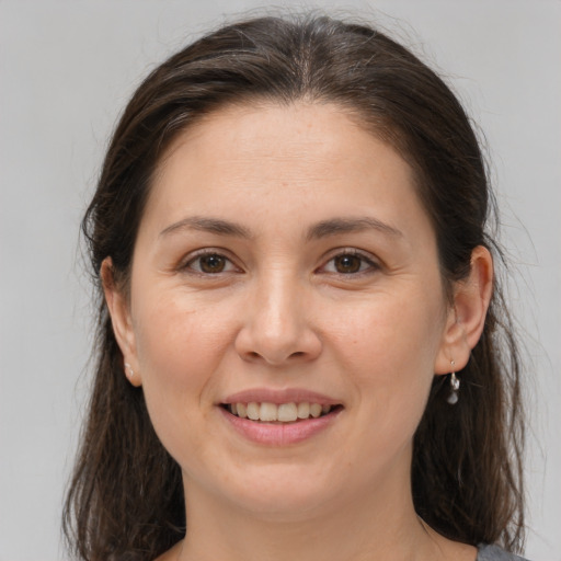 Joyful white young-adult female with medium  brown hair and brown eyes