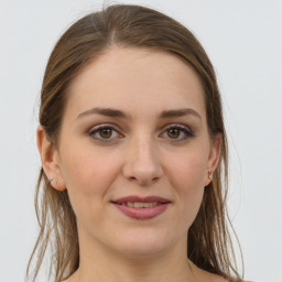 Joyful white young-adult female with long  brown hair and grey eyes