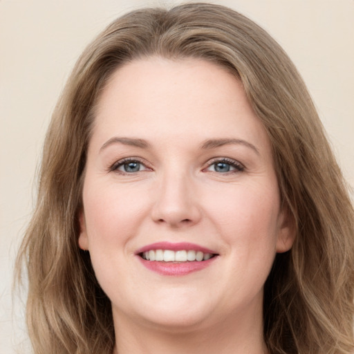 Joyful white young-adult female with long  brown hair and grey eyes