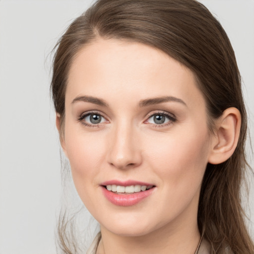 Joyful white young-adult female with long  brown hair and grey eyes