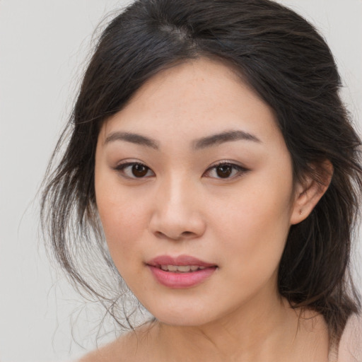 Joyful asian young-adult female with medium  brown hair and brown eyes