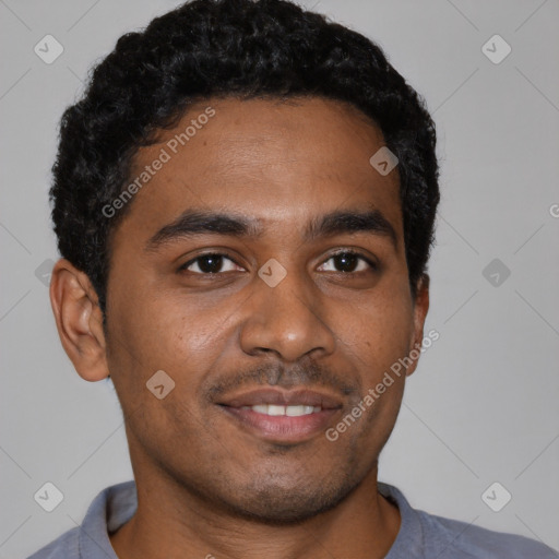 Joyful black young-adult male with short  brown hair and brown eyes