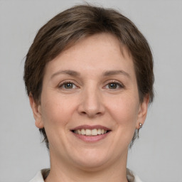 Joyful white adult female with short  brown hair and grey eyes