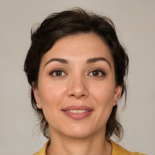 Joyful white young-adult female with medium  brown hair and brown eyes