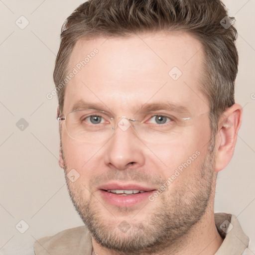 Joyful white adult male with short  brown hair and grey eyes