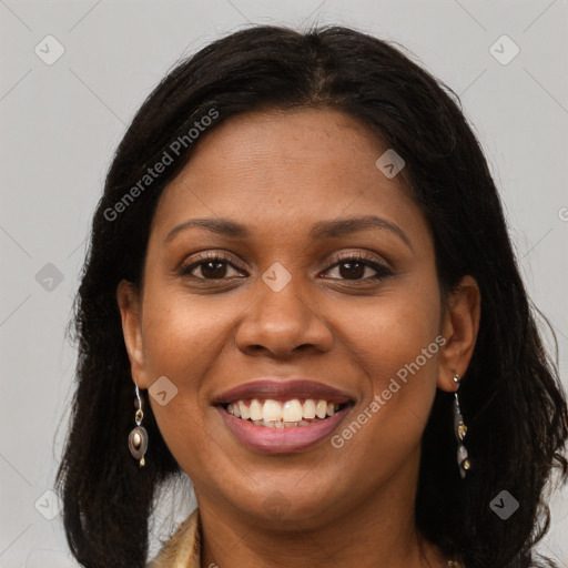 Joyful black young-adult female with long  brown hair and brown eyes