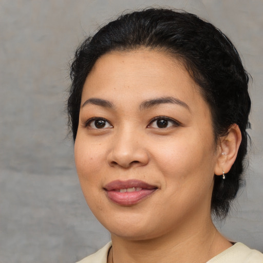 Joyful asian young-adult female with medium  brown hair and brown eyes