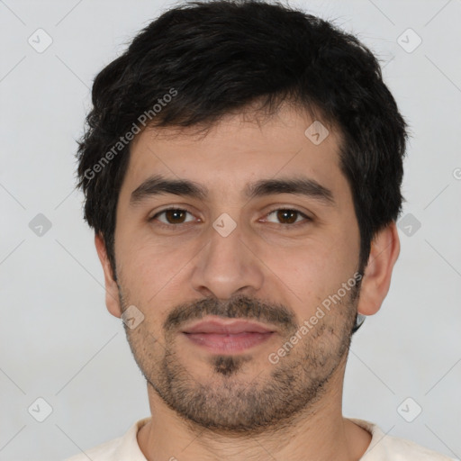 Joyful white young-adult male with short  black hair and brown eyes