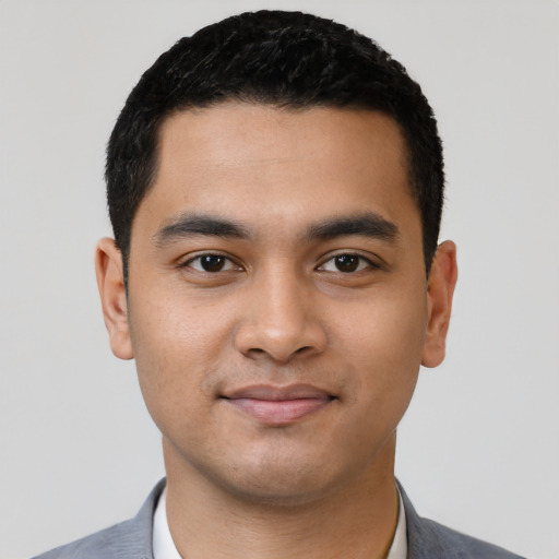Joyful latino young-adult male with short  black hair and brown eyes