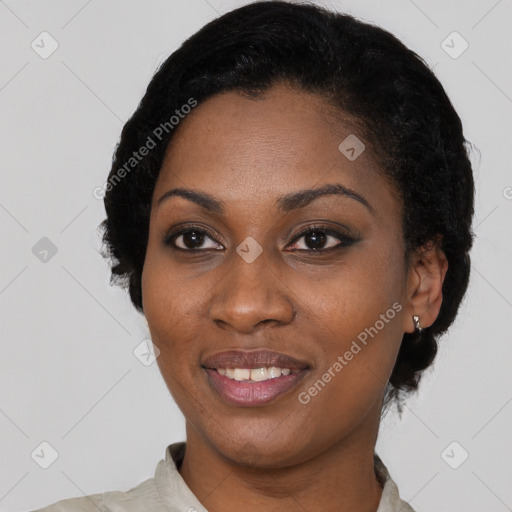 Joyful black young-adult female with short  black hair and brown eyes