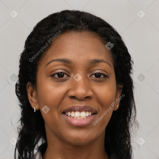 Joyful black young-adult female with long  brown hair and brown eyes