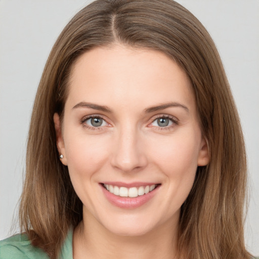 Joyful white young-adult female with long  brown hair and grey eyes