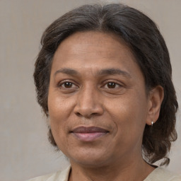 Joyful white adult female with medium  brown hair and brown eyes