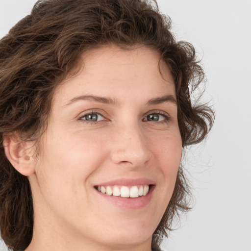 Joyful white young-adult female with medium  brown hair and green eyes