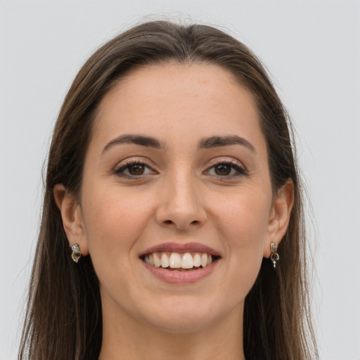 Joyful white young-adult female with long  brown hair and grey eyes