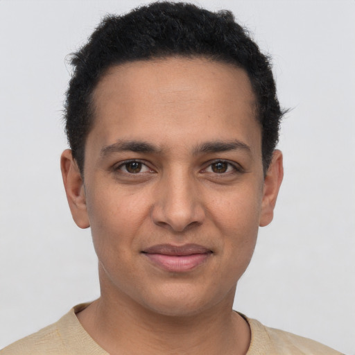 Joyful latino young-adult male with short  brown hair and brown eyes