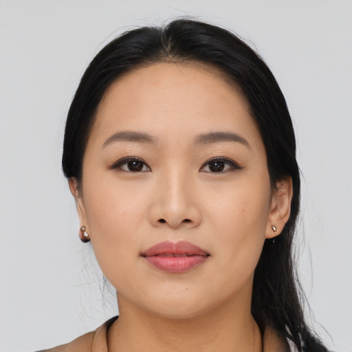 Joyful asian young-adult female with long  black hair and brown eyes