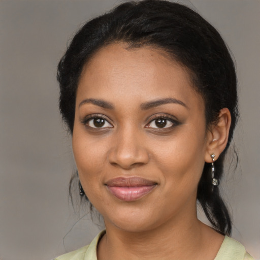 Joyful black young-adult female with medium  black hair and brown eyes