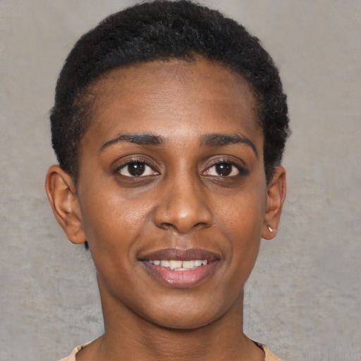 Joyful black young-adult female with short  brown hair and brown eyes